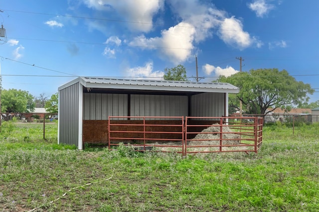 view of pole building with fence