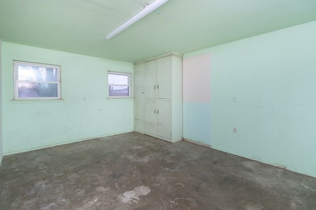 empty room featuring unfinished concrete flooring
