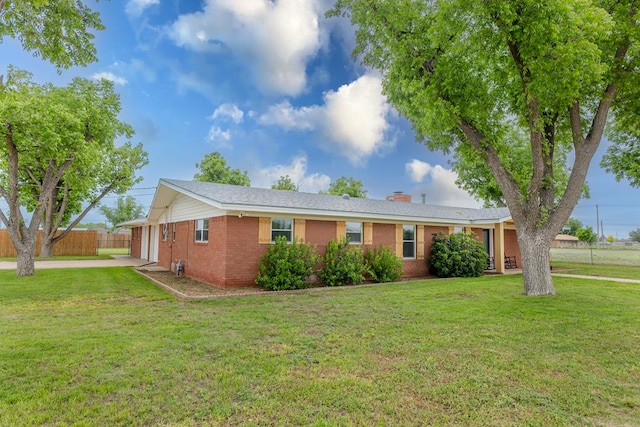 ranch-style house with a front lawn, brick siding, a chimney, and fence