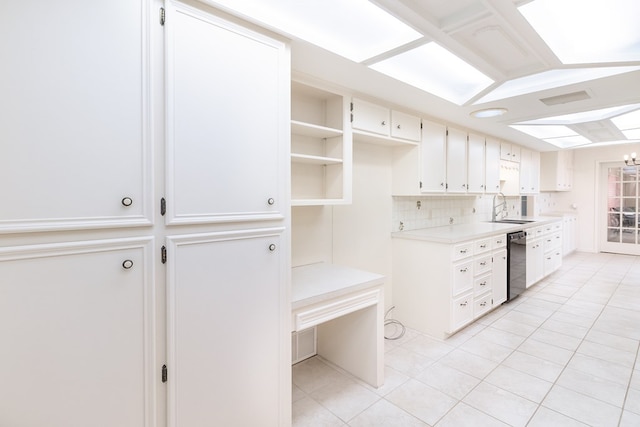kitchen with black dishwasher, light tile patterned flooring, a sink, light countertops, and tasteful backsplash