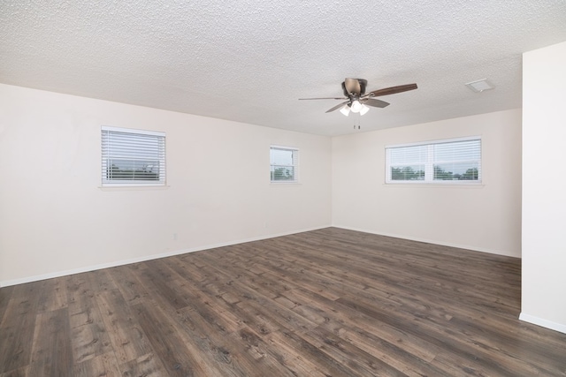 unfurnished room featuring dark wood-style floors, a textured ceiling, baseboards, and a ceiling fan