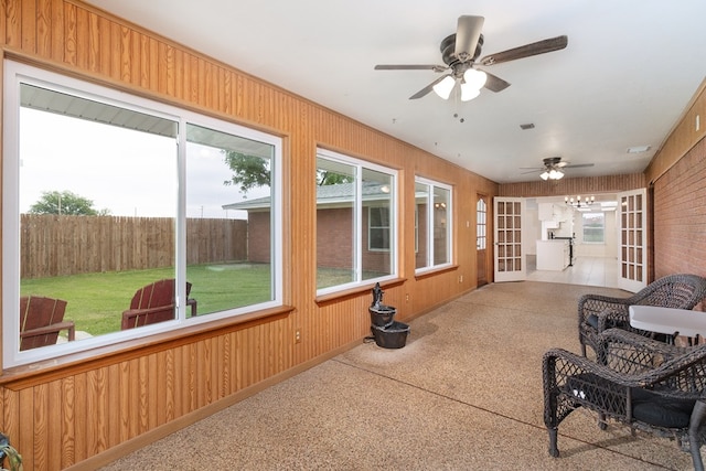 sunroom with plenty of natural light and wooden walls