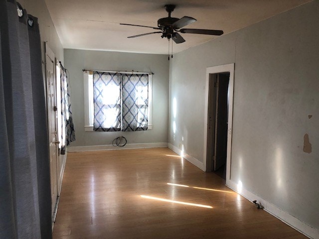 spare room featuring light hardwood / wood-style flooring and ceiling fan