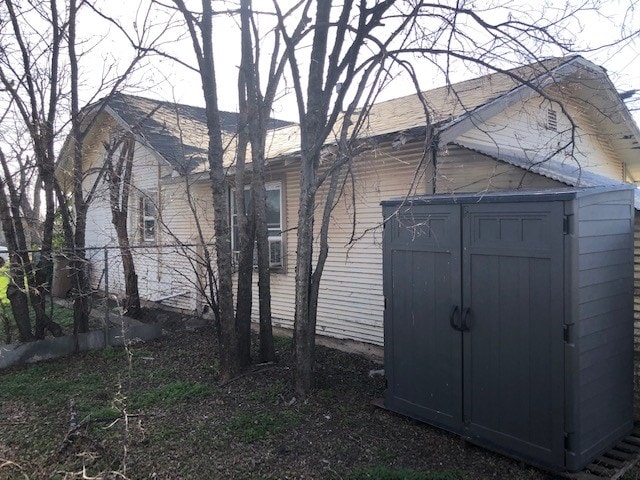 view of home's exterior with a storage unit