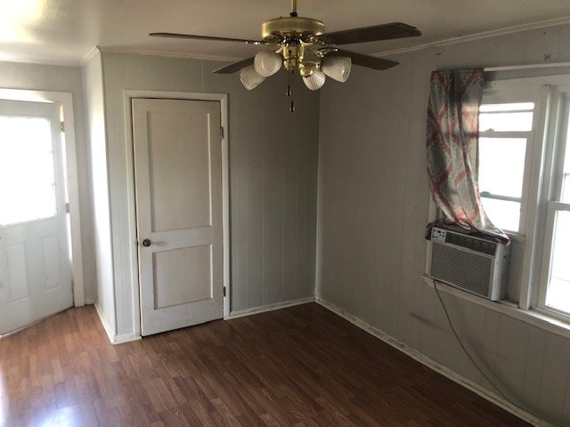 unfurnished room with ornamental molding, dark wood-type flooring, and cooling unit