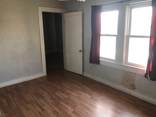 spare room with dark hardwood / wood-style flooring