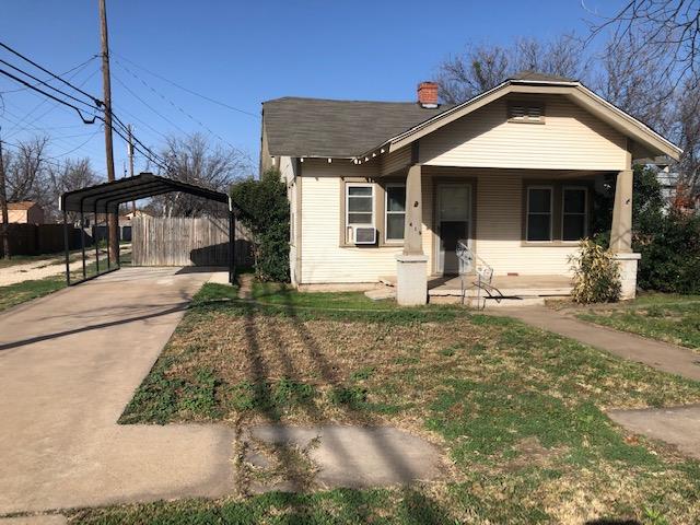 bungalow-style house featuring cooling unit and a carport