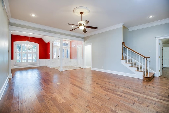 5413 Bent Oak Ct, San Angelo, TX 76904 - unfurnished living room with a chandelier, wood finished floors, stairway, a ceiling fan, and decorative columns