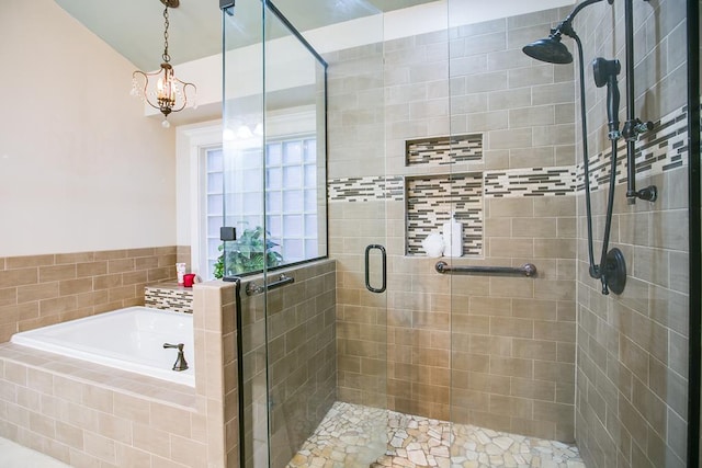 5413 Bent Oak Ct, San Angelo, TX 76904 - bathroom featuring a bath, a stall shower, and a chandelier
