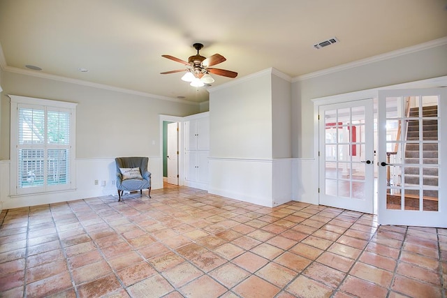 5413 Bent Oak Ct, San Angelo, TX 76904 - unfurnished room featuring french doors, wainscoting, ceiling fan, ornamental molding, and light stone finish flooring