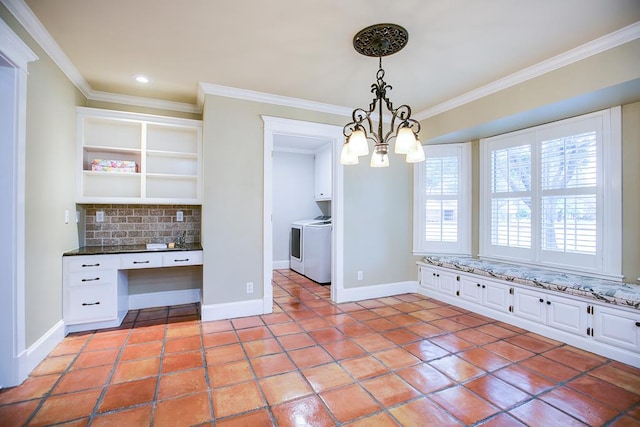 5413 Bent Oak Ct, San Angelo, TX 76904 - unfurnished dining area featuring washing machine and dryer, ornamental molding, baseboards, a chandelier, and light tile patterned floors