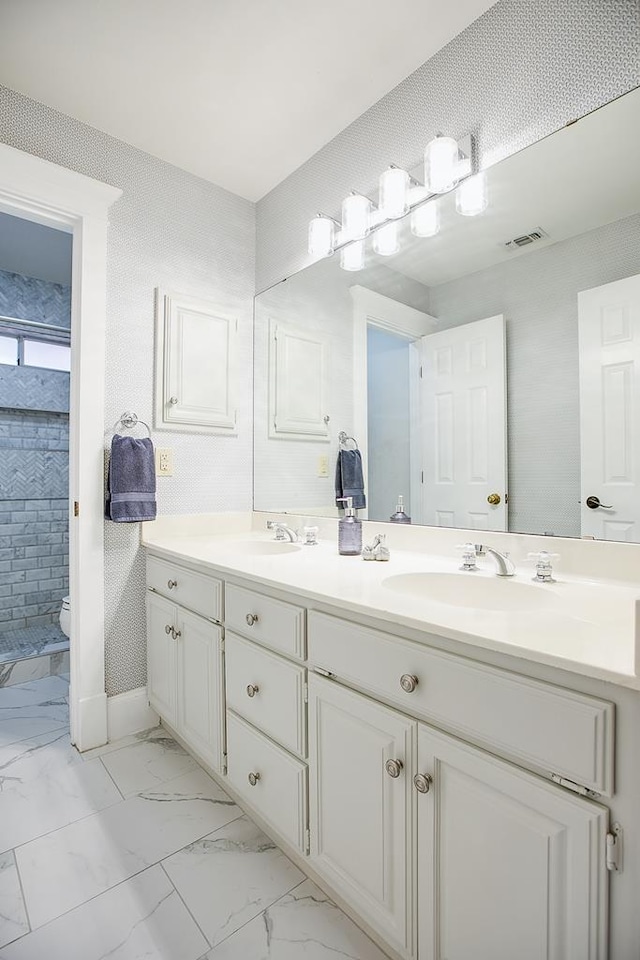 5413 Bent Oak Ct, San Angelo, TX 76904 - bathroom with double vanity, marble finish floors, and toilet