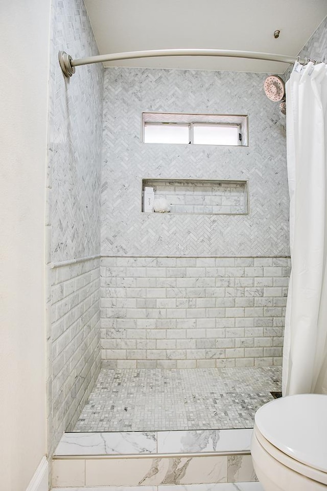 5413 Bent Oak Ct, San Angelo, TX 76904 - full bathroom with a tile shower, toilet, and marble look tile flooring