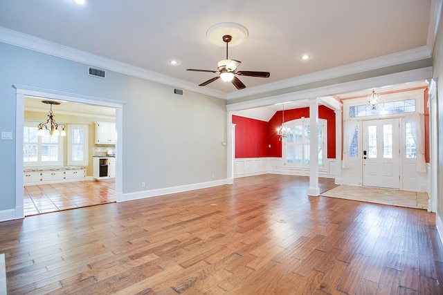 5413 Bent Oak Ct, San Angelo, TX 76904 - foyer entrance featuring a chandelier, ornamental molding, decorative columns, ceiling fan, and light wood-style floors