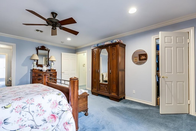 carpeted bedroom with crown molding, a spacious closet, a closet, and ceiling fan