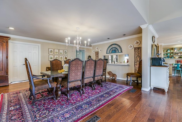 dining space with dark wood-type flooring, ornamental molding, and an inviting chandelier