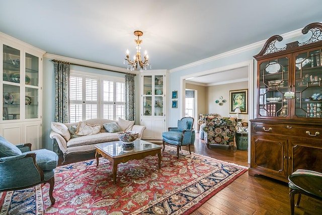 living room with an inviting chandelier, ornamental molding, and dark hardwood / wood-style floors