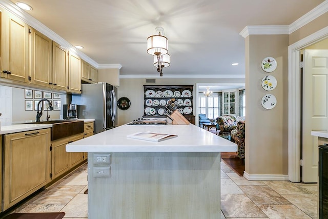 kitchen with stainless steel appliances, ornamental molding, a kitchen island, and decorative light fixtures