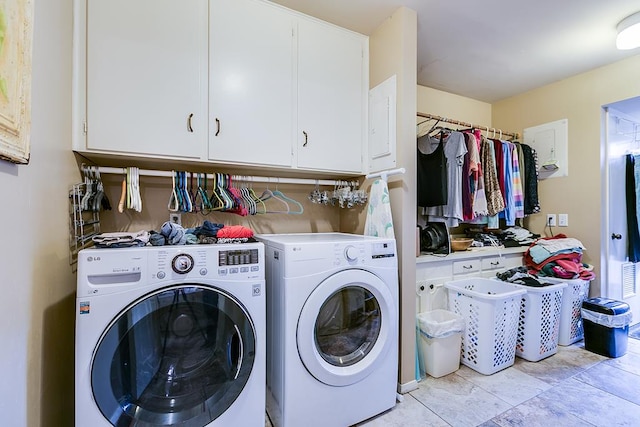 washroom with cabinets and washer and clothes dryer