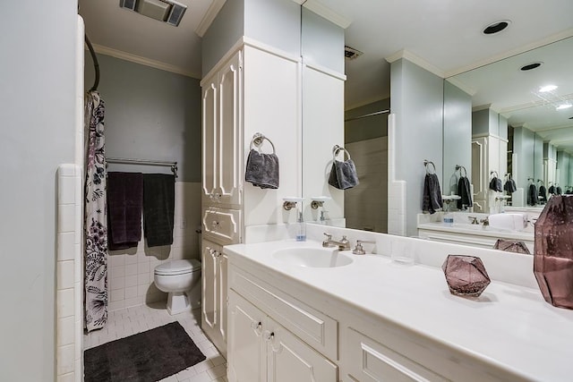 bathroom with tile patterned floors, toilet, tile walls, ornamental molding, and vanity