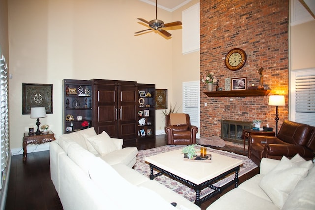 5114 Fairway Dr, San Angelo, TX 76904 - living room with a high ceiling, dark wood-style flooring, ceiling fan, a brick fireplace, and crown molding