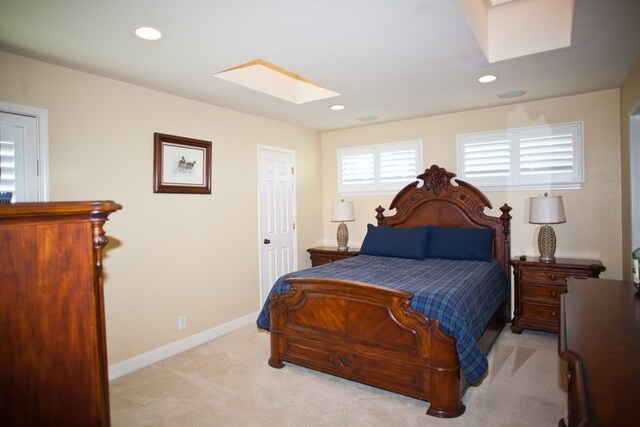 5114 Fairway Dr, San Angelo, TX 76904 - bedroom featuring a skylight, light colored carpet, baseboards, and recessed lighting