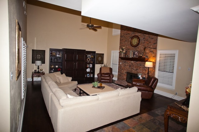 5114 Fairway Dr, San Angelo, TX 76904 - living room with lofted ceiling, a ceiling fan, a brick fireplace, baseboards, and wood finished floors
