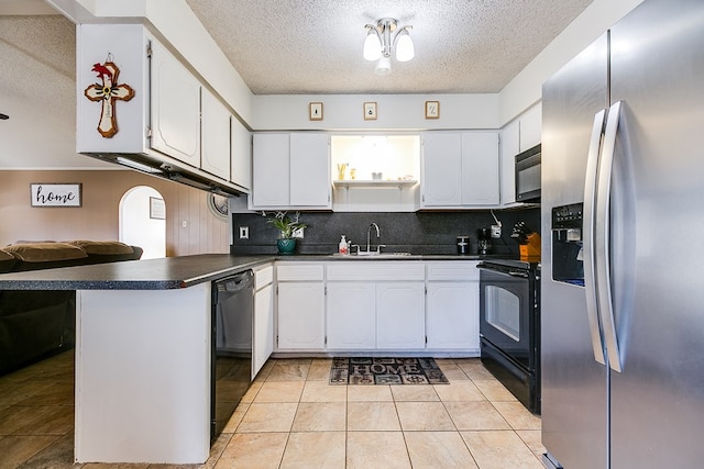 kitchen featuring kitchen peninsula, white cabinets, and black appliances