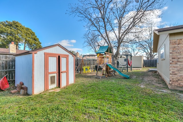 view of jungle gym with a yard and a shed