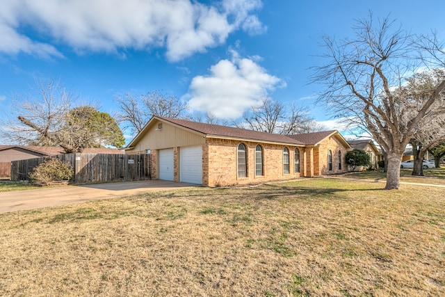 view of front of property featuring a garage and a front lawn