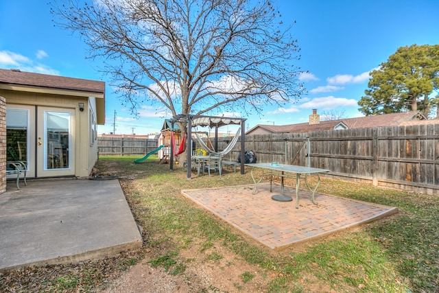 view of yard with a playground and a patio