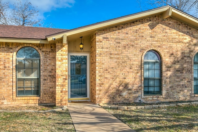 doorway to property featuring a yard