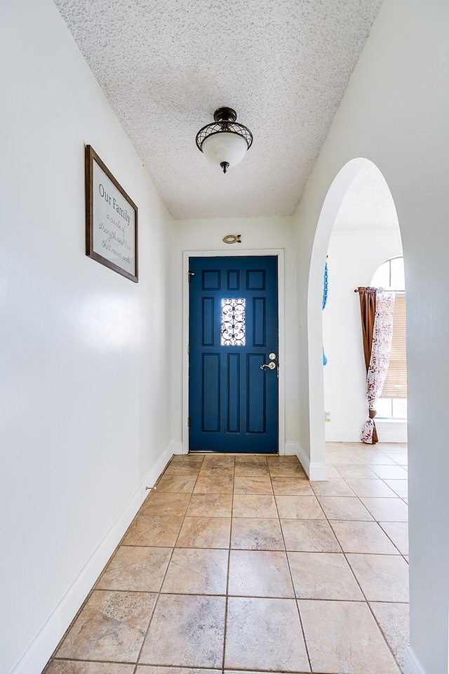 foyer entrance featuring a textured ceiling