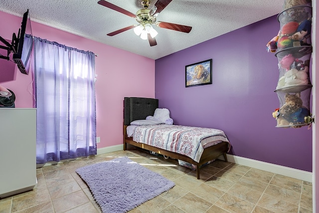 bedroom with a textured ceiling and ceiling fan