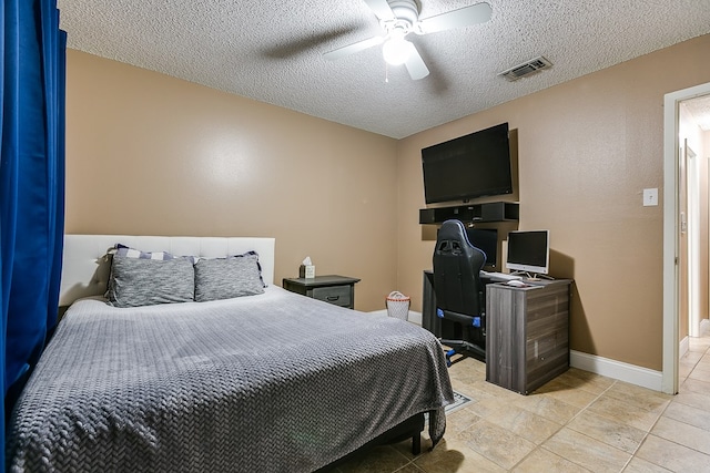 bedroom with light tile patterned floors, a textured ceiling, and ceiling fan