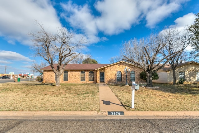 ranch-style home featuring a front yard