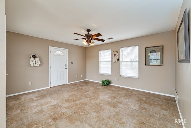 entryway featuring baseboards, a ceiling fan, and visible vents