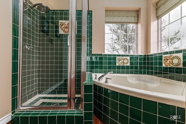 full bathroom featuring a stall shower and a garden tub