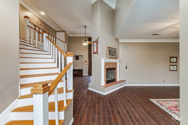 interior space featuring crown molding, wood finished floors, ceiling fan, and visible vents