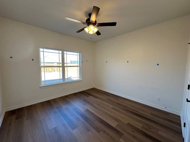 7409 Easton Ave, San Angelo, TX 76904 - unfurnished room featuring dark wood-style flooring, baseboards, and a ceiling fan