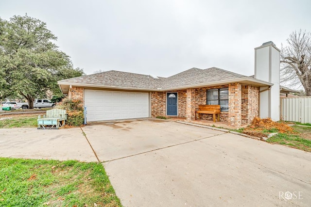 ranch-style home featuring a chimney, an attached garage, concrete driveway, and brick siding
