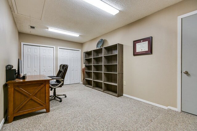 office area featuring light carpet and a textured ceiling