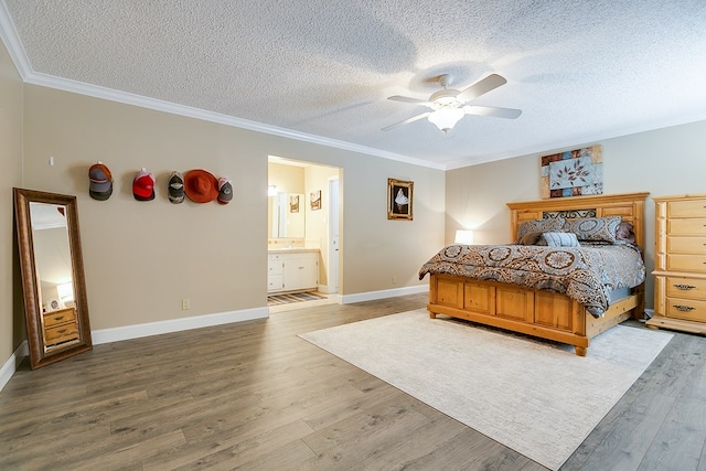 bedroom featuring baseboards, ceiling fan, ornamental molding, a textured ceiling, and light wood-type flooring