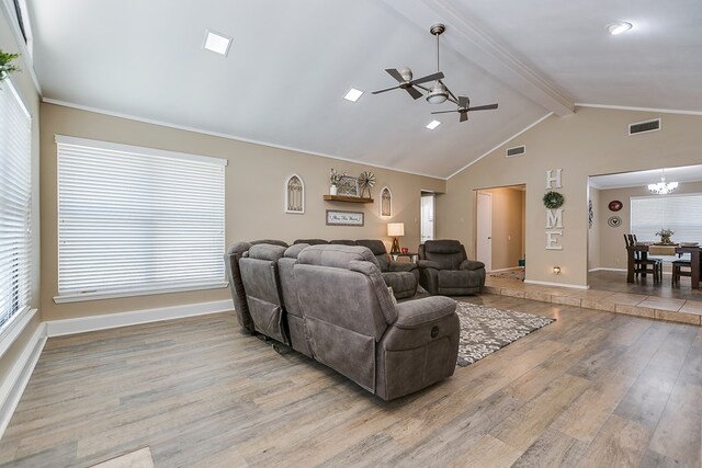 living area with baseboards, visible vents, wood finished floors, vaulted ceiling with beams, and ceiling fan with notable chandelier