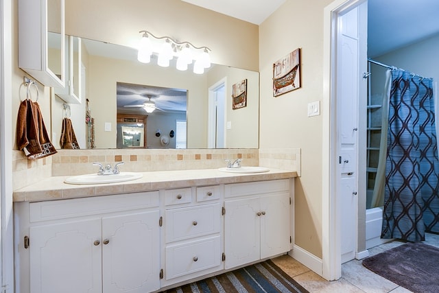 bathroom featuring shower / tub combo with curtain, a sink, backsplash, and double vanity