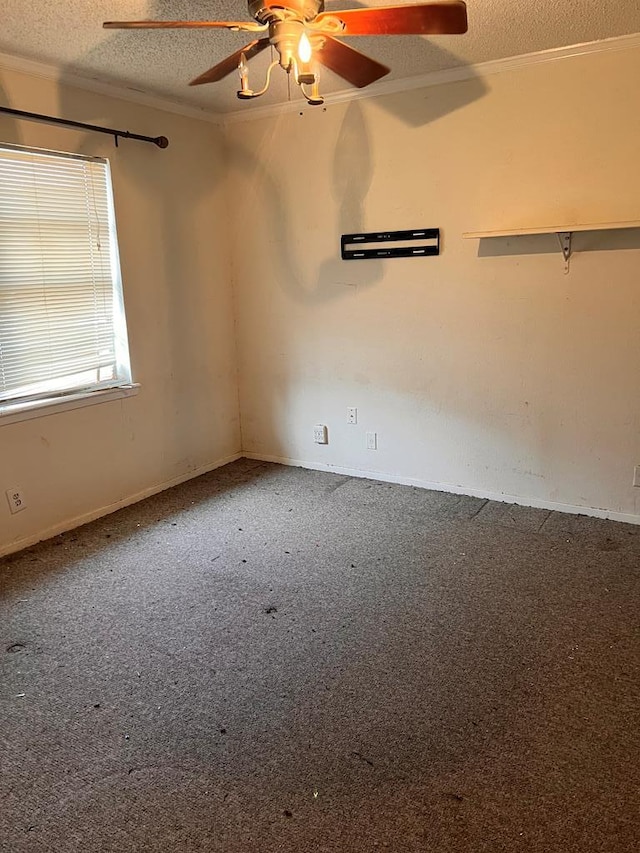 carpeted spare room with ceiling fan and a textured ceiling