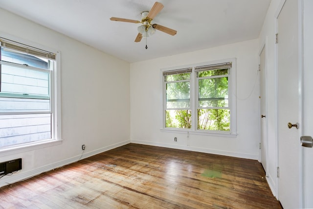 empty room featuring baseboards, ceiling fan, and wood finished floors