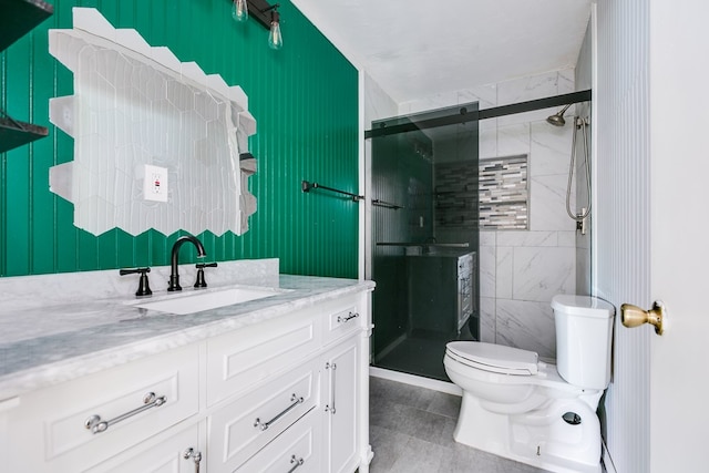 full bathroom featuring vanity, tile patterned floors, a stall shower, and toilet