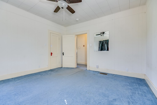 empty room featuring ceiling fan and carpet flooring