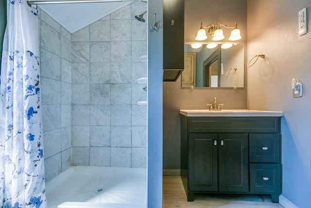 bathroom featuring vanity, a shower with curtain, and vaulted ceiling